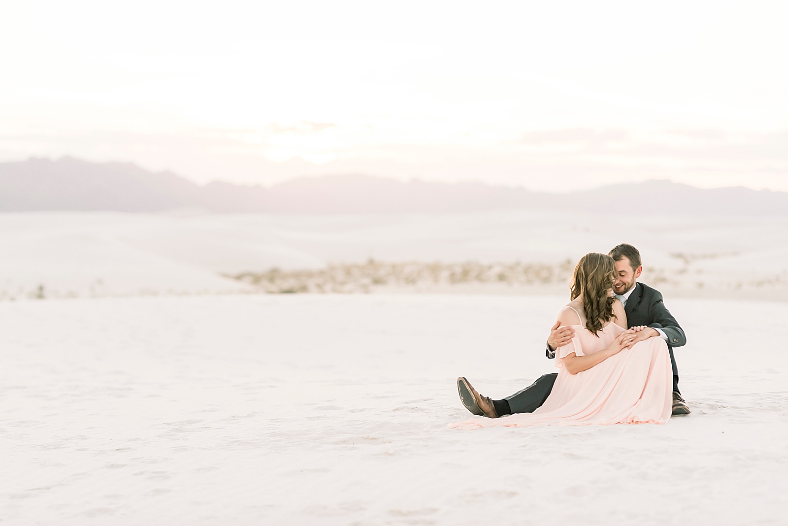 portrait of couple at White Sands, New Mexico at sunset